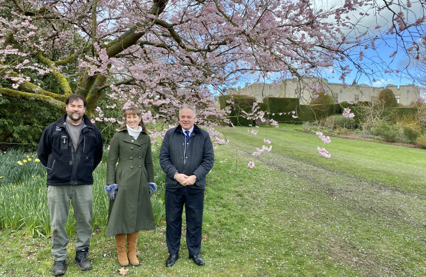 Simon Baynes MP by a blossom tree with General Manager Lizzie Champion & Head Gardener David Lock at Chirk Castle