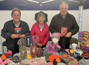 Simon Baynes MP with Rosemary and Peter at their market stall