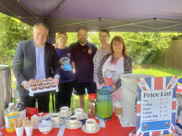 Simon Baynes MP at the refreshment stand at the Coronation Picnic in the Park in Bronington